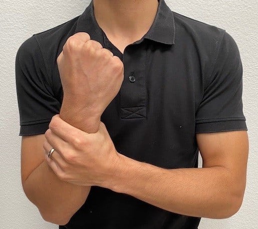 What does this sign mean? (hand grabbing wrist)