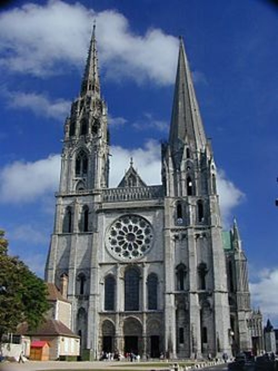 <p>Height and grandeur, pointed arches, high ceilings and light and airy buildings, stained glass, tall towers</p>