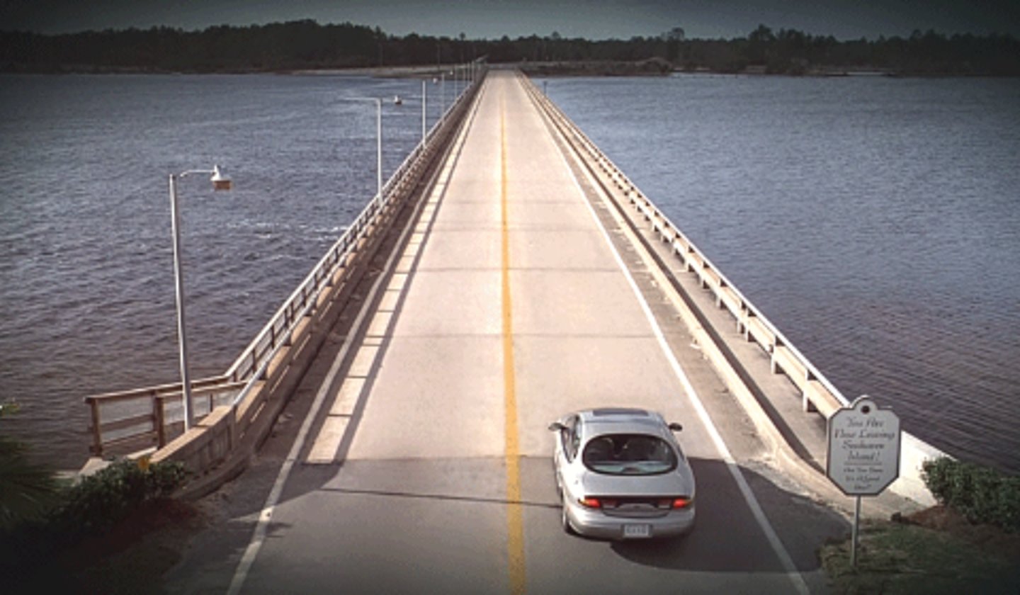 <p>Bridges represent the way out, but their length and being over water represents confinement - they offer only a long and difficult escape route. Other bridges in the film are simply a dead end - offering no escape at all.</p>