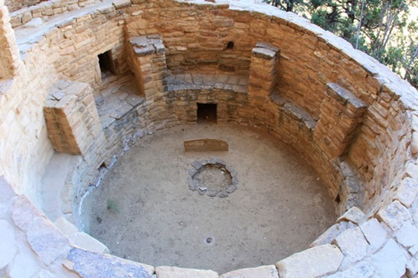 <p>a circular room wholly or partly underground, used for religious rites</p>