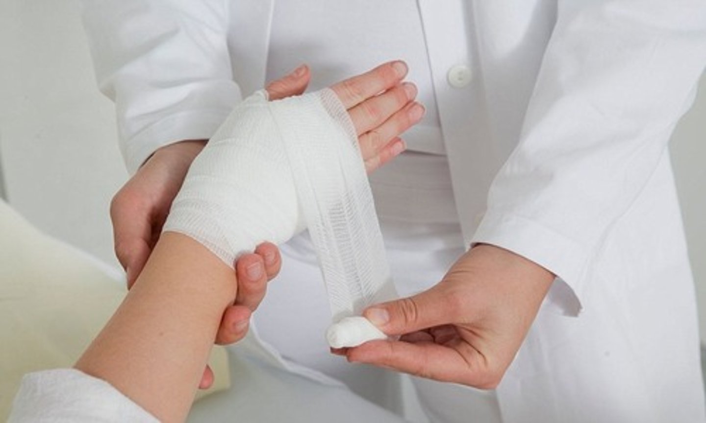 <p>to clean, apply a medical treatment to, and bandage a wound</p>