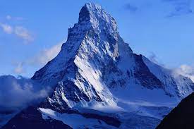 <ul><li><p>three-sided, pointed mountain peak</p></li><li><p>Formed when 3+ back-to-back corrie glaciers carve away at the top of a mountain</p></li></ul>