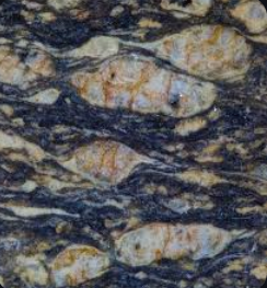 <p>large porphyroblasts that have a lens-shaped appearance, often found in metamorphic rocks. </p>