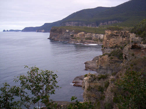 The rock layers at the bottom of this cliff are much older than those at the top.