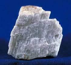 <p>Whiteish cream color in appearance. Has prismatic cleavage, hardness of about 6-6.5, leaves a white streak. </p>