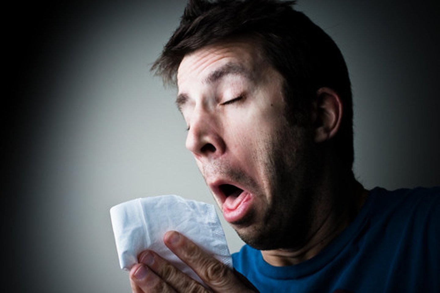 <p>(v.) to loudly blow air out of your nose or mouth in a sudden uncontrolled way</p>