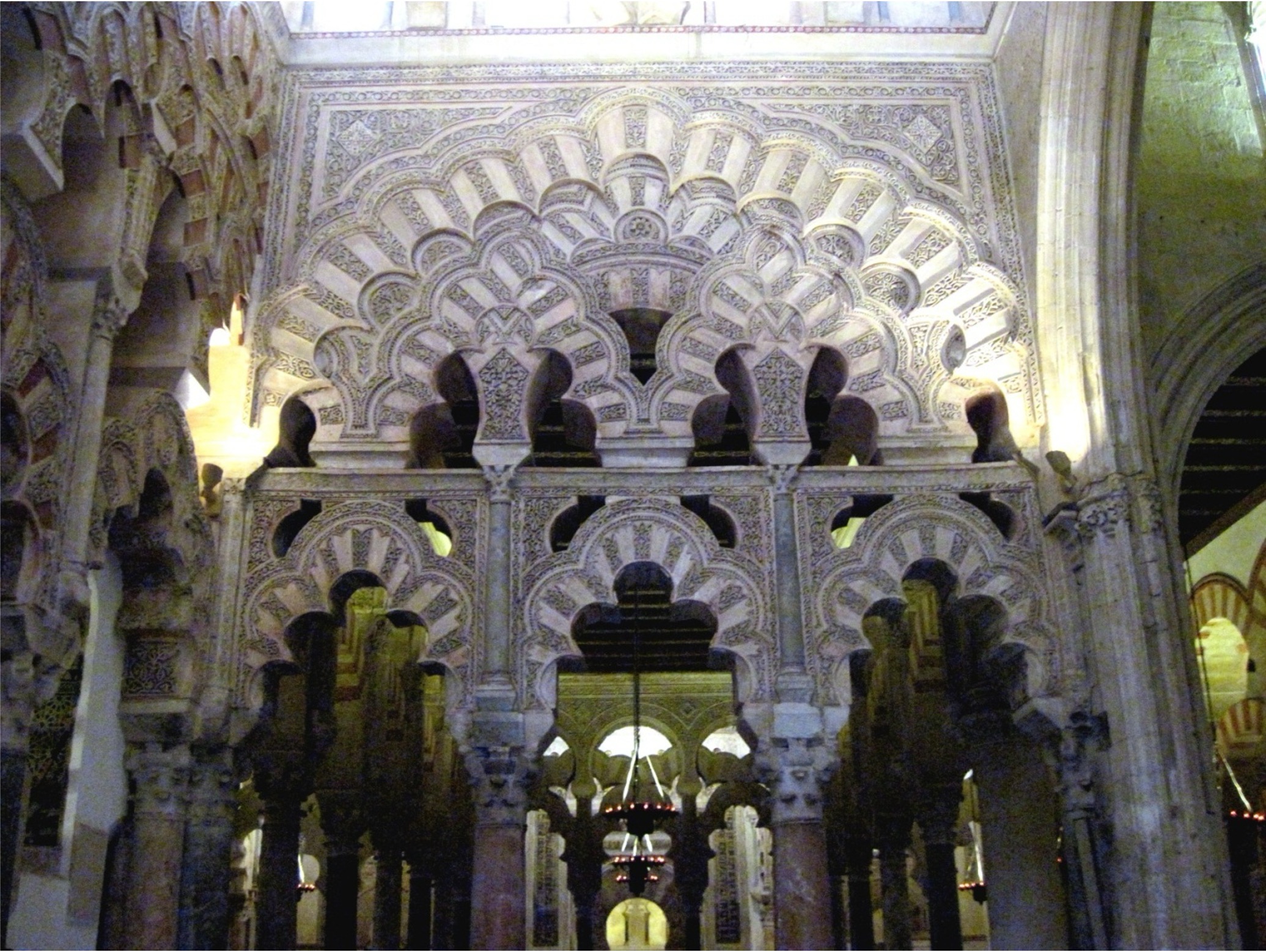 <ul><li><p>Three domes decorate the area in front of the mihrab – the maqsura reserved for the royal family</p><ul><li><p>Interlaced polylobed arches mark off the maqsura from the rest of the prayer hall</p></li></ul></li><li><p>The central maqsura dome (in front of the mihrab room) is the highlight of al-Hakam’s additions to the mosque -<span> </span>like its sister, <strong>it rests on ribs that are purely ornamental</strong></p><ul><li><p><strong>The dome is fluted, and divided into 8 segments (melon or pumpkin dome; looks like a giant bundt pan in the middle)</strong></p></li></ul></li><li><p>Many of the decorative motif come from Visigothic works – the Visigoths were the inventors of the horseshoe arch</p></li></ul><p></p>