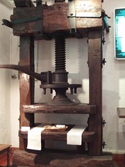 A mechanical device for transferring text or graphics from a woodblock or type to paper using ink. Presses using movable type first appeared in Europe in about 1450