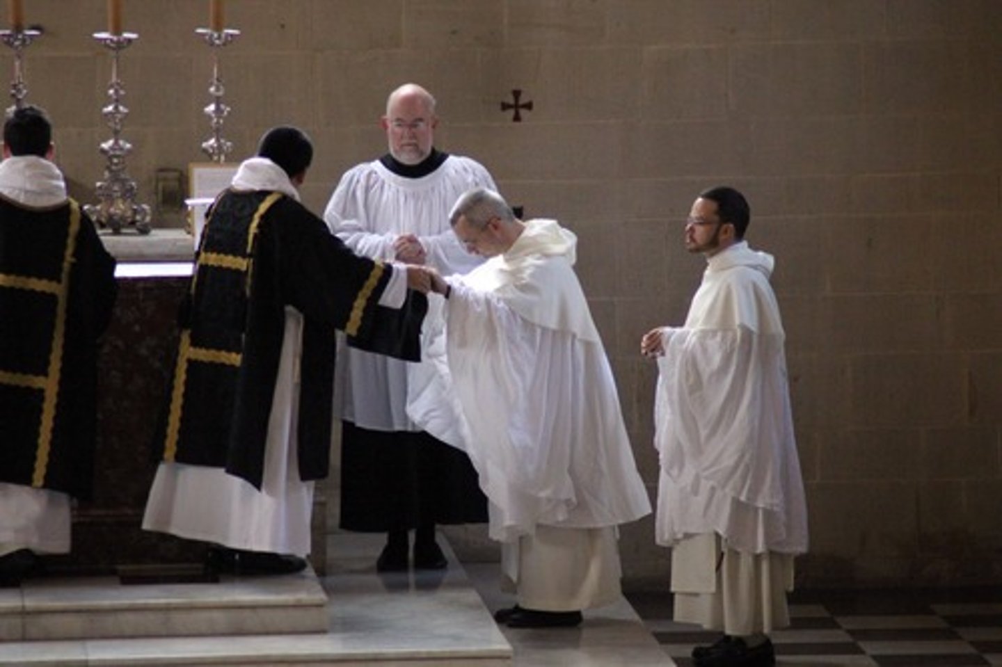 <p>a person assisting a priest in a religious service or procession.</p>