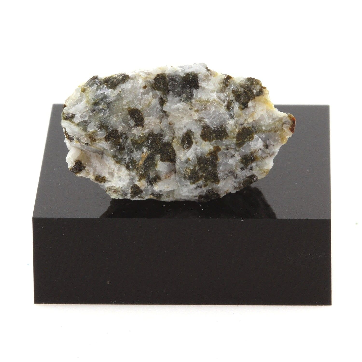 <ul><li><p>Medium grey, medium grained, leucogabbro </p></li><li><p>mafic phaneritic rock containing 5-40% ferromagnesian minerals (mostly as pyroxene) and dominated by plagioclase (&gt;50% as anorthite)</p></li><li><p>The greater proportion of plagioclase relative to clinopyroxene imparts a colour that is lighter than for true gabbro (which tends to be dark green/grey to black)</p></li><li><p>Note that the prefix leuco means “white” Probably represents the upper gabbro layer of the ophiolite</p></li></ul>