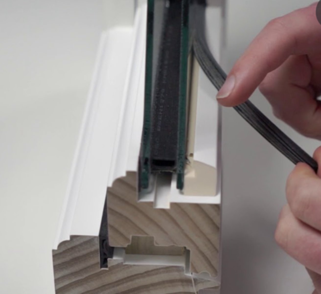 <p>Rubber or vinyl gasket compressed between glass and frame</p>