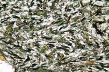 <p>is a texture in igneous rocks characterized by a parallel arrangement of elongated crystals, usually feldspar, giving a layering or banded appearance. </p>