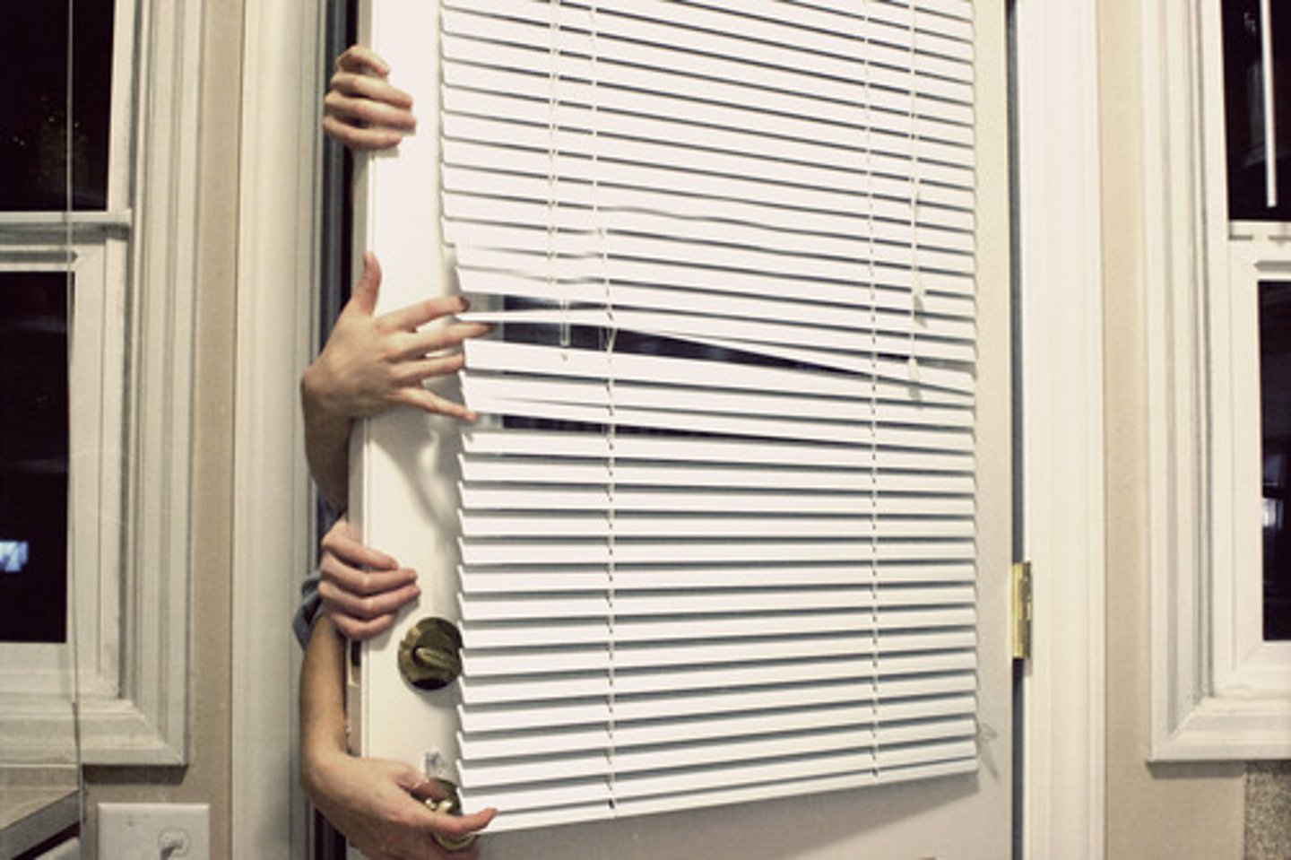<p>Horizontal slats of aluminum like Venetian blinds but they are only 1/2 to 1" wide; the angle of the slats is controlled with a plastic rod; they can be pulled up to expose the entire window area</p>