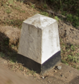 <p>Short tapered white bollards with black base</p>