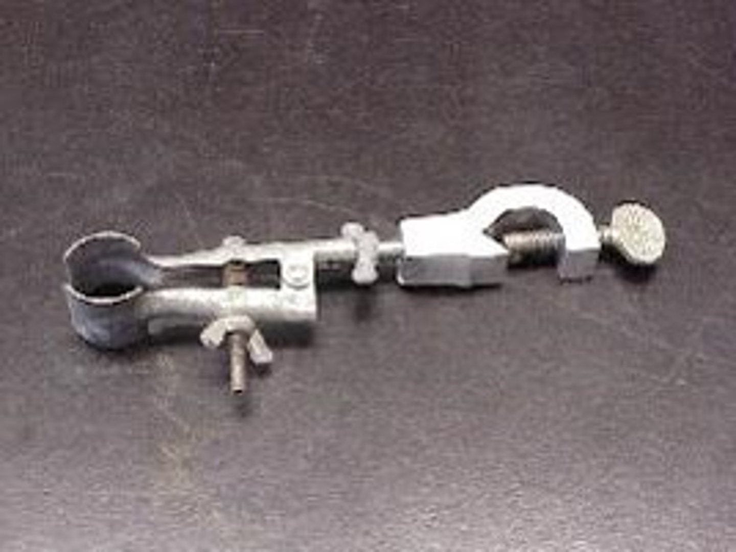 <p>holds a test tube to a ring stand</p>