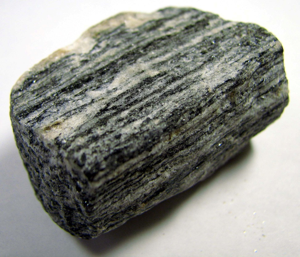 <p>Strong foliation, alternating light/dark bands, metamorphic</p>