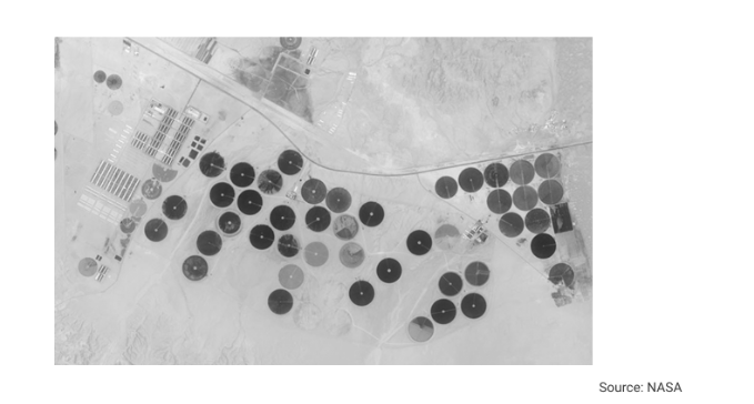 <p>Based on the different types of land use shown in the image, which of the following best explains why soil salinization is a concern in the arid landscape shown?</p><ul><li><p>a. Land is being farmed so intensively that soil nutrients are degraded to the point that crops will not grow.</p></li><li><p>b. Fields are left fallow after being farmed intensively so that nutrients in the soil may be replenished.</p></li><li><p>c. Irrigation increases the salt content of the soil, which disrupts the growth of crops and degrades soil fertility.</p></li><li><p>d. Multiple crops are being planted in the same field, which increases the chances of pest damage.</p></li><li><p>e. Forests are being cleared as land is repurposed for agricultural uses, which reduces biodiversity in the region.</p></li></ul>