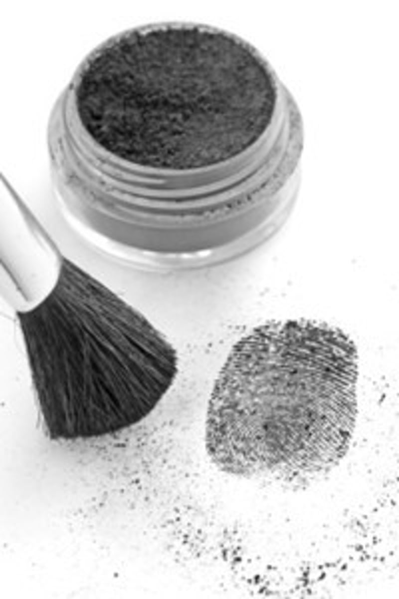 <p>Applying powder to make prints visible.</p>