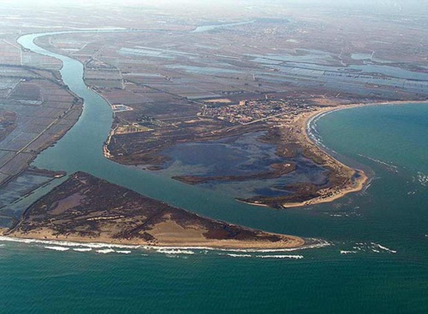 <p>A land-form located at the mouth of the river , made up of dis-tributaries and deposits of silt and material.</p>