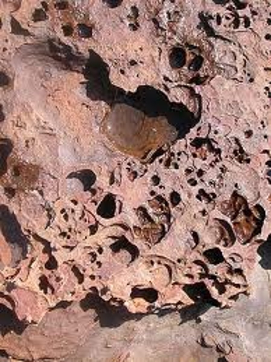 <p>the acid in rainwater dissolves rock (carbonic acid breaks up chalk &amp; limestone)</p>