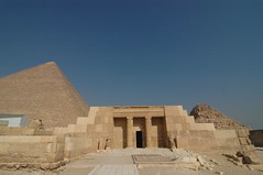 an ancient Egyptian mudbrick tomb with a rectangular base and sloping sides and flat roof