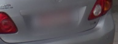 <p>Red lettering license plate</p>