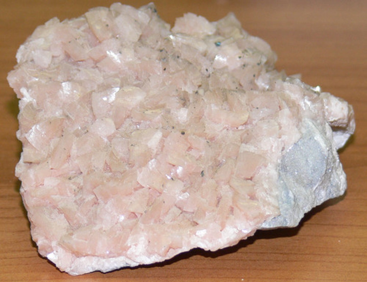 <p>Thin, platy cream-colored crystals possibly has black specks between crystals.</p>