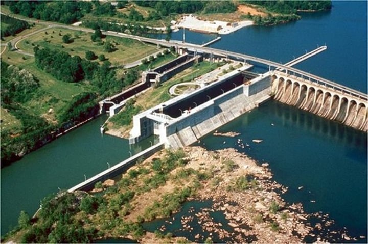 <p>an enclosure with gates built in a canal or river so that ships can be raised or lowered by changing the water level</p>