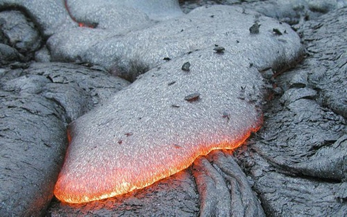 <p>magma that pushes through rock layers and erupts above the surface as lava</p>