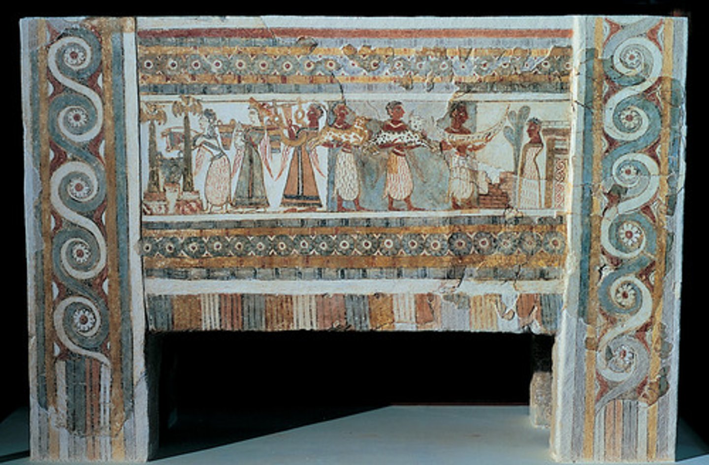 <p>A coffin (sarcophagus) that depicts a Minoan burial. One side depicts the deceased, looking at gifts being brought to him thought to facilitate the deceased's existence in the underworld.<br><br>S: Shows us about minoan culture in relation to the underworld (they believed in one)</p>