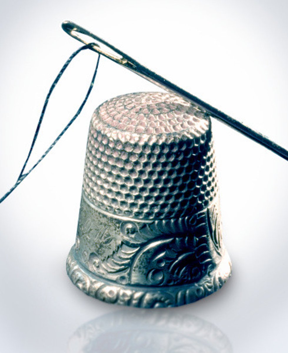 <p>a small metal cap to protect the finger while sewing</p>