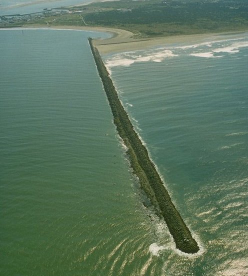 <p>A long, narrow structure that <span>intends to keep sand from flowing into a channel; intended to protect an inlet.</span></p>
