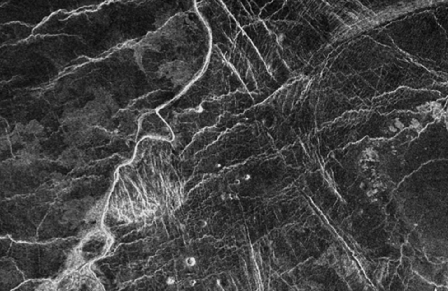<p>What planet is this?</p><p>What created the sinuous channel and the bright straight lines?</p>