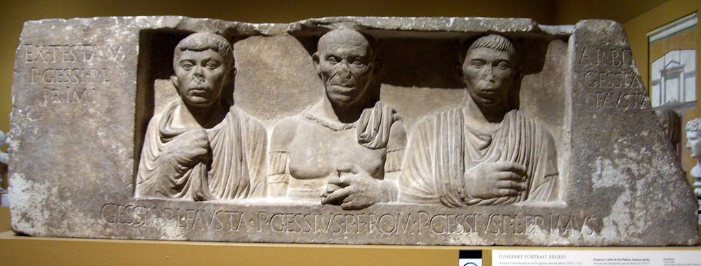 <p>-Virtuous women were shown holding their robes to their chest -Patrician in the middle, looks older (like a monke) -Slave died, Patricia commissioned this, the lady oversaw the making of the sculpture -Living depicted next to dea DISTINCTLY ROMAN</p>