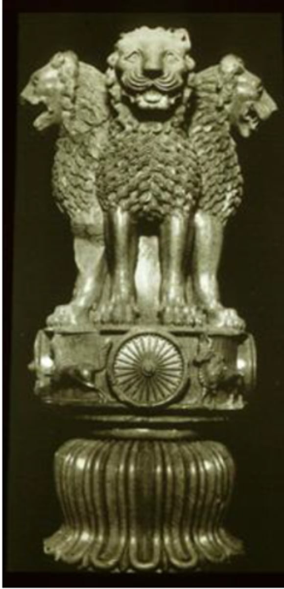 <p>Ruler: Mauryan King Ashoka</p><p>Medium: Stone capital with four lions seated back-to-back</p><p>Historical Context: Ashoka converted from brutal tyrant to Buddhist after repenting violence</p><p>Function: Monumental pillars throughout South Asia inscribed with Buddhist edicts</p><p>Symbolism: Lions = upholders of dharma; wheel = wheel of dharma (Buddhist law)</p><p>Modern Legacy: Wheel on current Indian flag (Ashoka Chakra) based on this sculpture</p><p>Inscription: "Schism edict" warning against conflict in Buddhist communities</p>