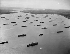 Naval ships escort merchant ships to protect from German U-boat attacks