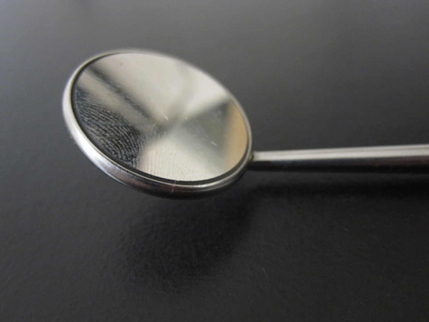 <p>Instrument used to view oral cavity, reflect light, and retract cheek</p>