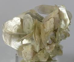 <p>Yellowish/White; fairly seethrough since it’s typically in thin sheets. Has basal cleavage, and a hardness of 2.5-3. sorta pearly when looking at it. It’s also lowkey bendable</p>