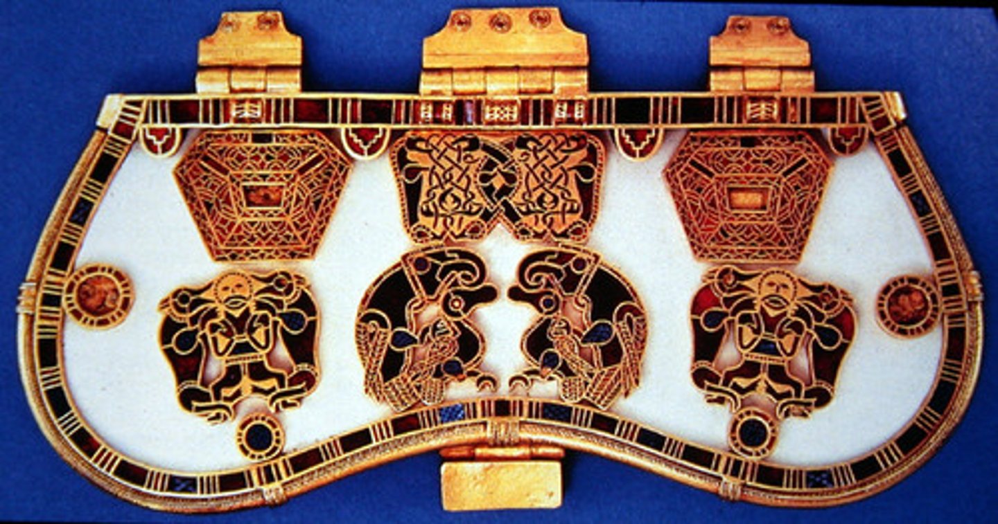 <p>Hiberno-saxon; 625 CE</p><p>Heraldic composition= center figure is flanked by two animals</p><p>Bilateral symmetry, animal interlace, made out of bone, context= found silver/gold ingots used to make coins underneath this purse thing</p><p>Cloisonne= soddering metal strips filled with glass or stones.</p>