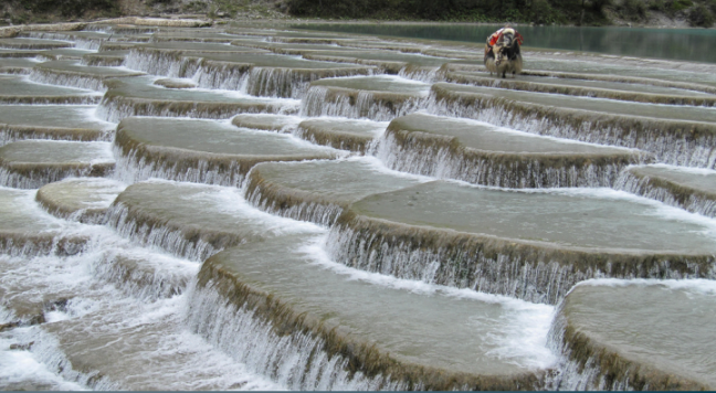 <ul><li><p><strong>Travertine Terraces:</strong></p><ul><li><p>Found in areas in where there is an abundant amount of <strong>hot groundwater</strong></p></li><li><p>Hot water carries <strong>dissolved material</strong> and when it reaches the surface it quickly cools and deposits minerals on existing rock<strong> </strong></p></li></ul></li></ul><p></p>