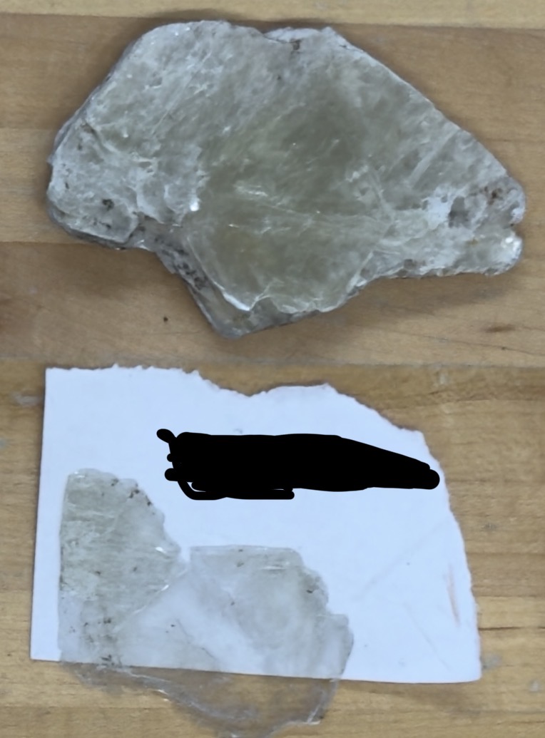 <p>Light colored, breaks off in sheets</p>