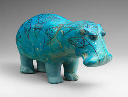 <p>made of faience which makes it blue</p><p>is a hippo representing isfet/chaos</p><p>has a different colored leg because of modern restoration</p>