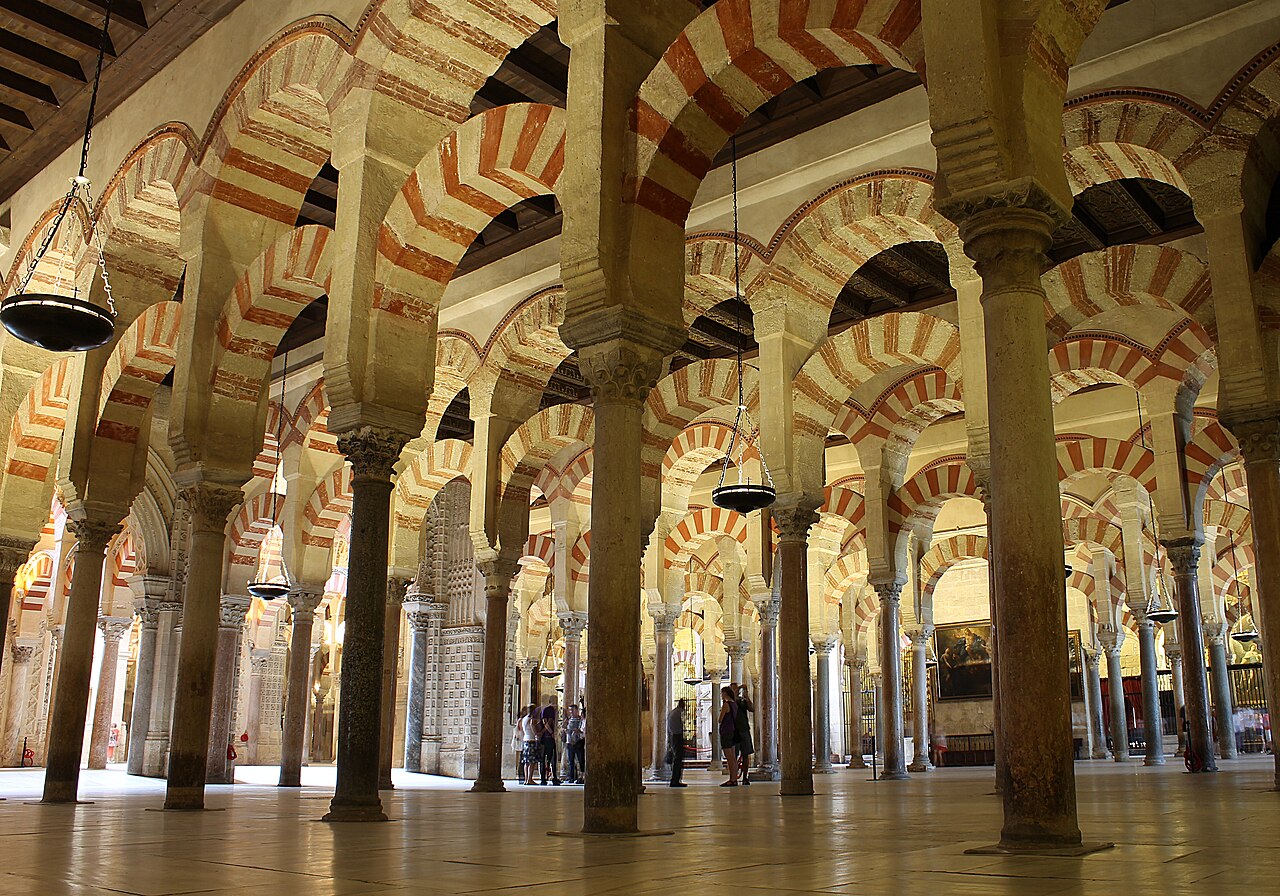 <ul><li><p>Built during the reign of Abd al-Rahman of the Umayyad Emirate of Cordoba  </p><ul><li><p>Expansions were added until 990 </p></li></ul></li><li><p>Features naves which use elegant star vaulting </p><ul><li><p>The whole was intricately decorated with colored marbles and precious stones </p></li></ul></li></ul><p></p>