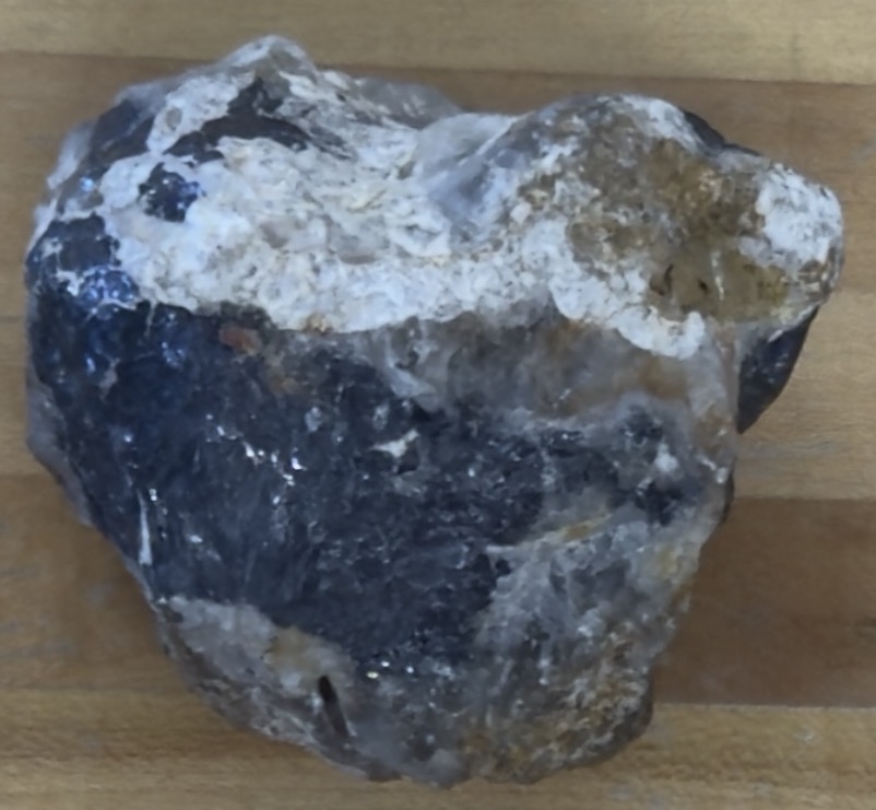 <p>Dark grey streaks on porcelain, metallic/shiny</p>