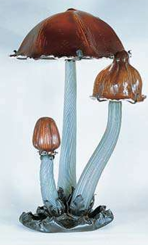 <p>A table lamp by Emille Galle (1902). This Art Nouveau lamp uses glass stems and shades to house three electric lightbulbs. It has been suggested that the three fantastic mushrooms represent the three ages of man: infancy, adolescence, and maturity. The florid forms and bright color are typical of French Art Nouveau design. </p>