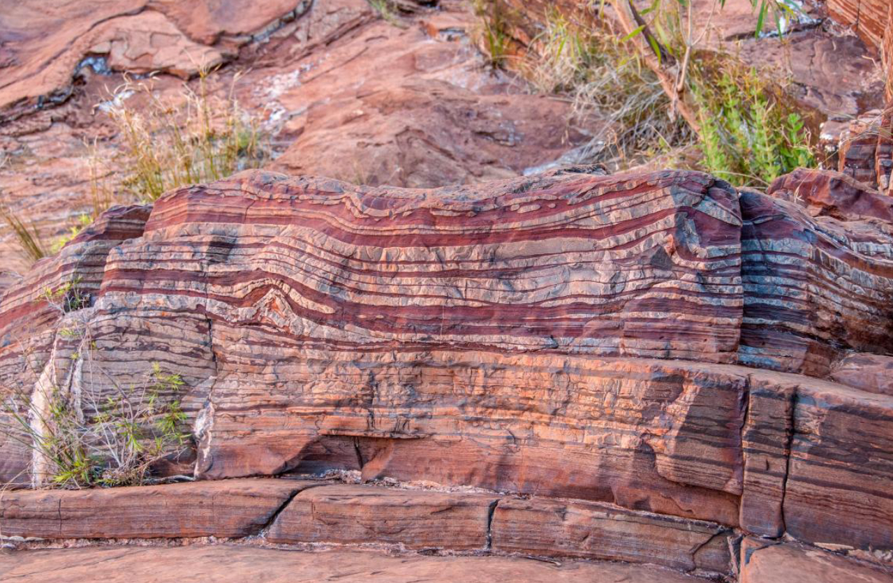 <p>Oxygen dissolved into the water, reacted with iron, and precipitated out as iron oxide resulting in the build up in sediment, forming red bands of rock containing iron ore</p>