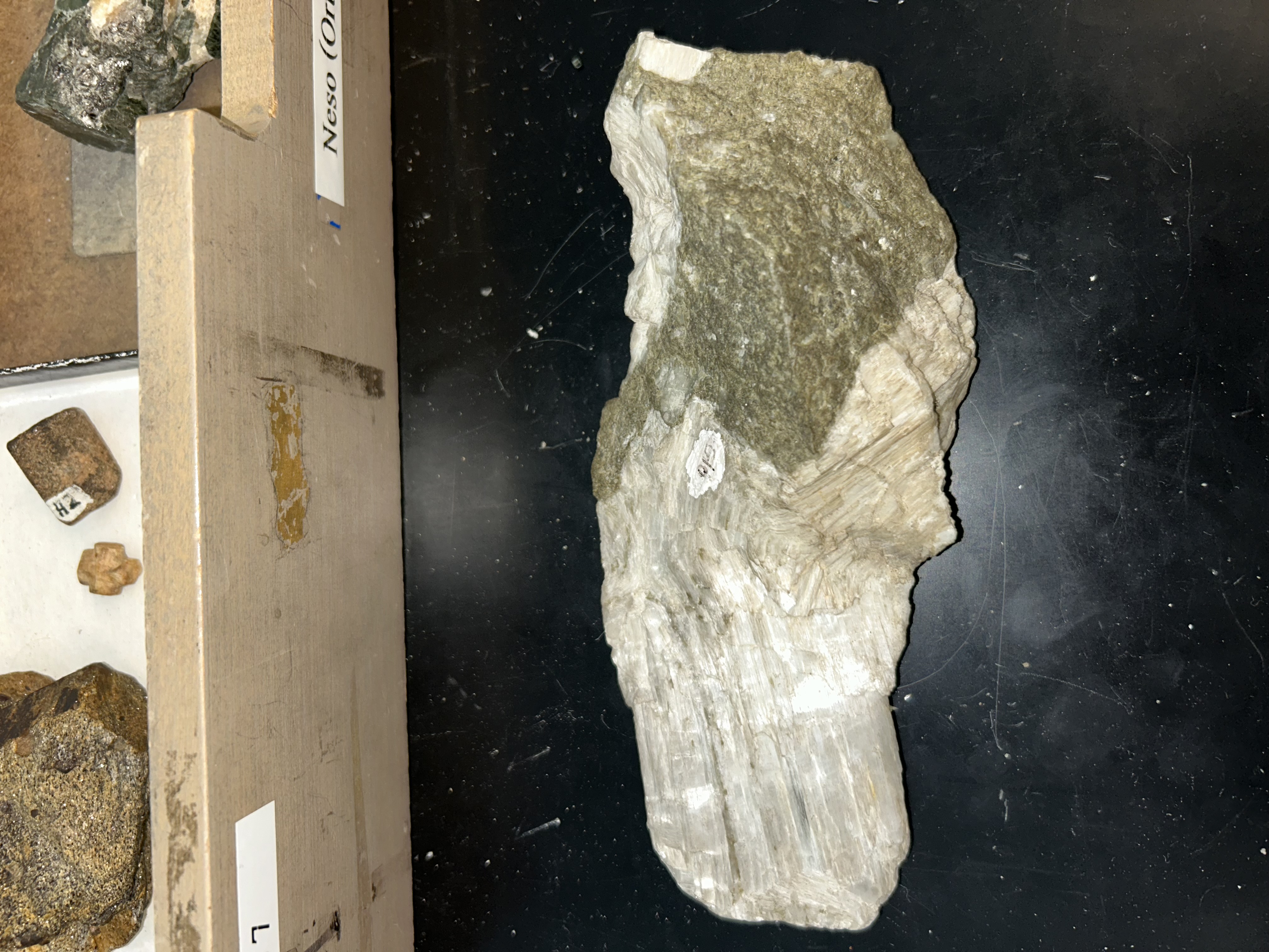 <ol><li><p>triclinic</p></li><li><p>﻿﻿﻿splintery/elongate crystals</p></li><li><p>﻿﻿﻿vitreous, pearly on cleavage surfaces</p></li><li><p>﻿﻿﻿white, colorless to grey</p></li><li><p>﻿﻿﻿two perfect cleavages @ ~ 90°</p></li></ol>