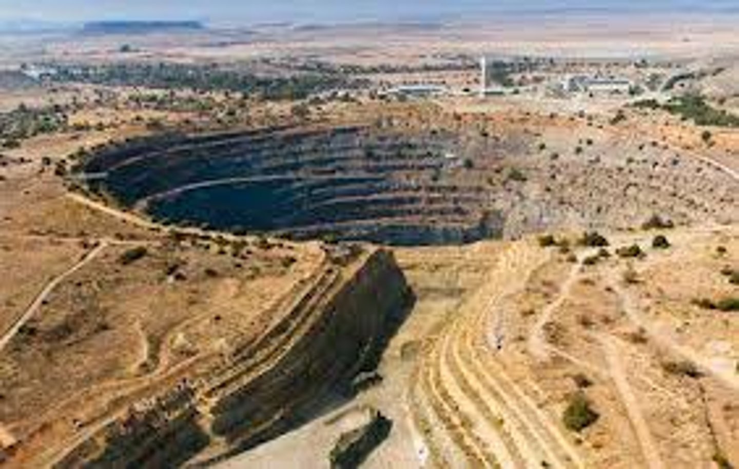 <p>Mining at the surface by excavating an open pit.</p>