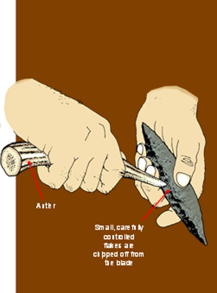 <p>using small tools to break off small flakes</p>