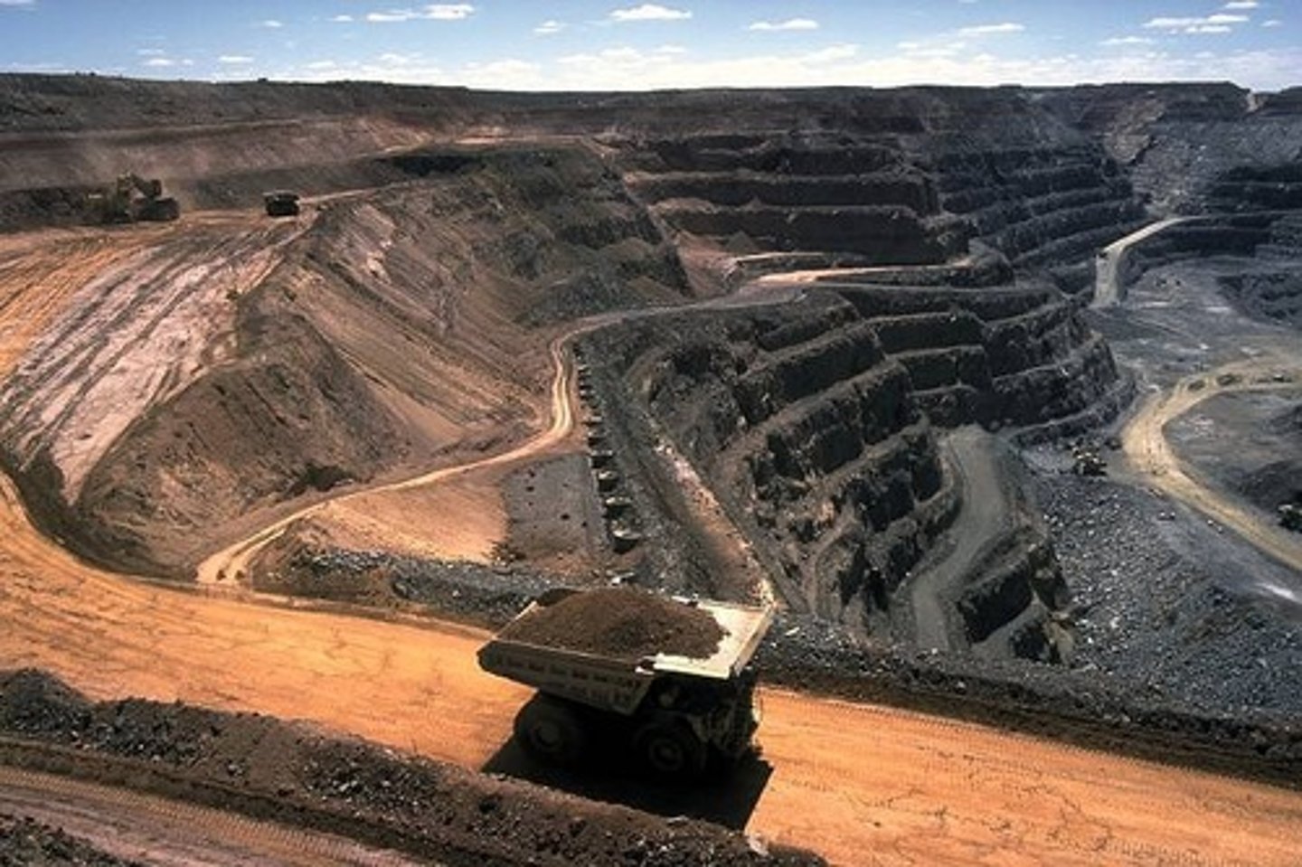 <p>The removal of large portions of soil and rock, called overburden, in order to access the ore underneath. An example is strip mining, which removes the vegetation from an area, making the area more susceptible to erosion.</p>